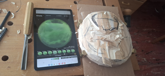 Workbench with chisel, tablet and a wooden disc